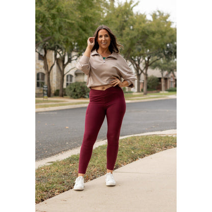 High-waisted maroon crossover leggings with pockets by Julia Rose, Julia Rose women’s maroon full length leggings lifestyle image