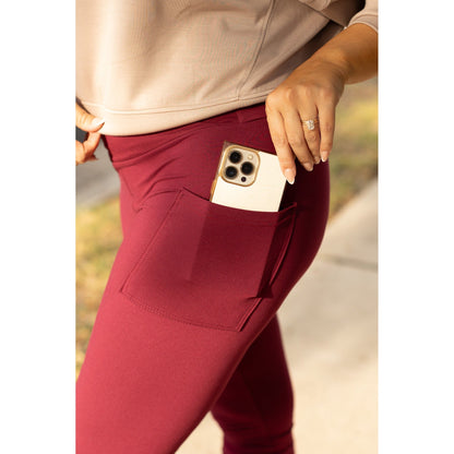 High-waisted maroon crossover leggings with pockets by Julia Rose, Julia Rose women’s maroon full length leggings lifestyle image