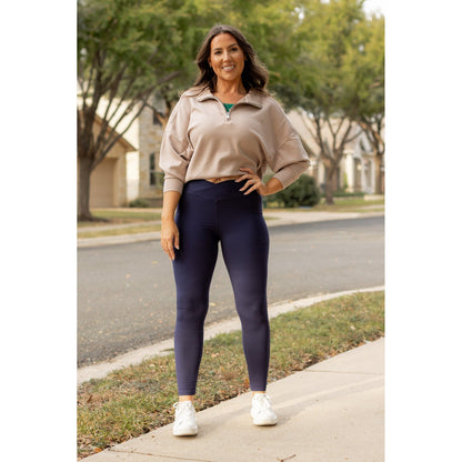 High-waisted navy crossover leggings with pockets by Julia Rose, Julia Rose women’s navy full length leggings lifestyle image