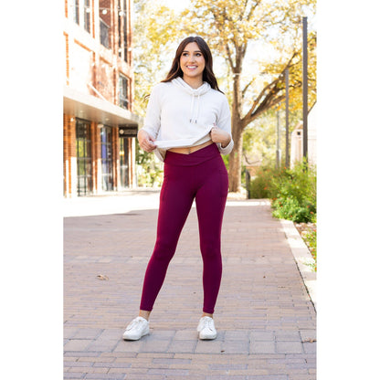 High-waisted maroon crossover leggings with pockets by Julia Rose, Julia Rose women’s maroon full length leggings lifestyle image