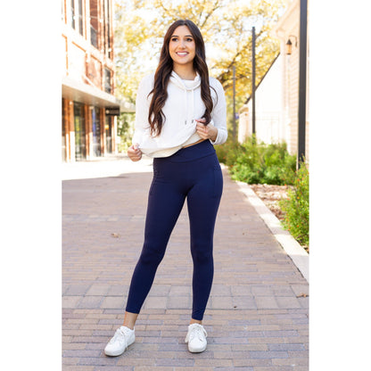 High-waisted navy crossover leggings with pockets by Julia Rose, Julia Rose women’s navy full length leggings lifestyle image