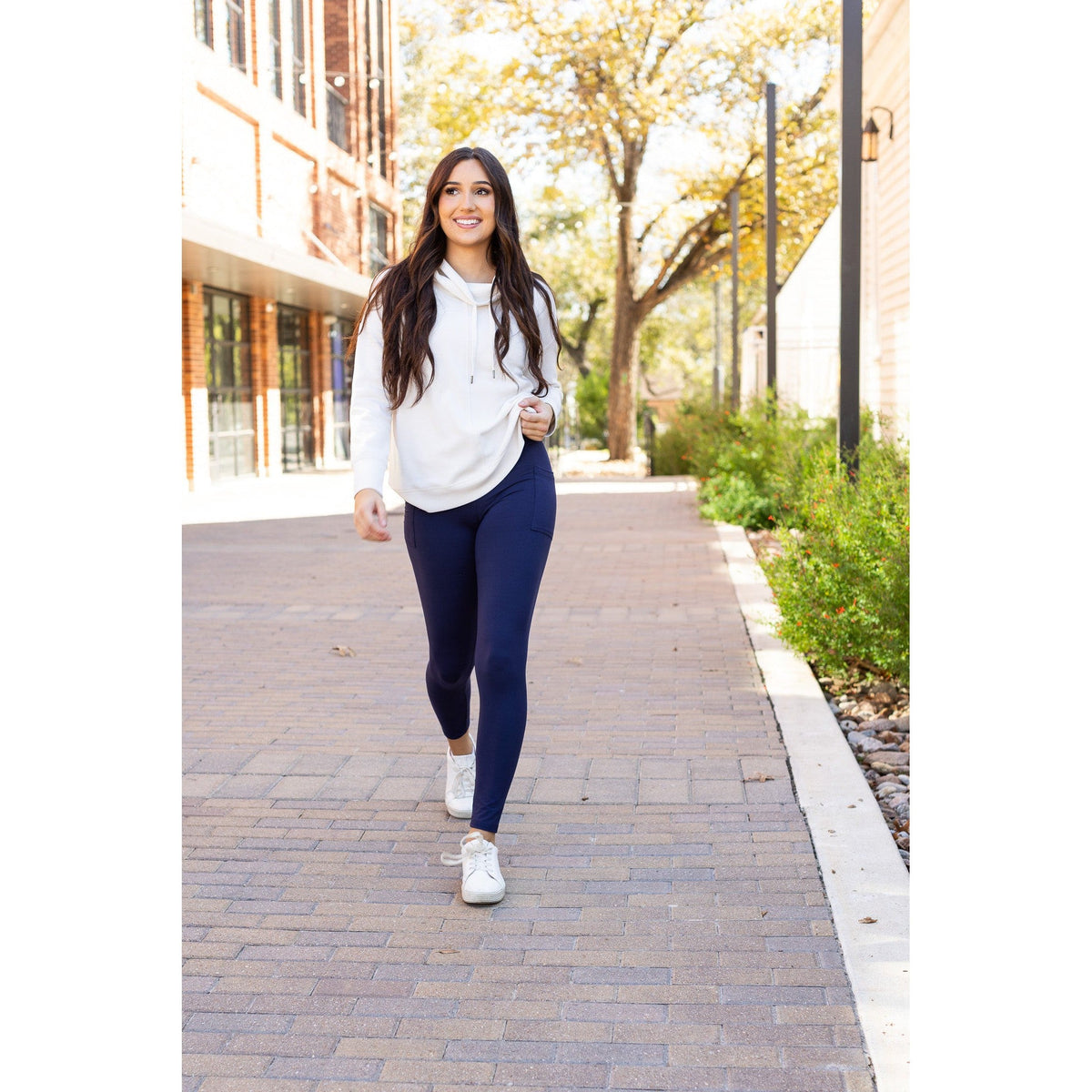 High-waisted navy crossover leggings with pockets by Julia Rose, Julia Rose women’s navy full length leggings lifestyle image