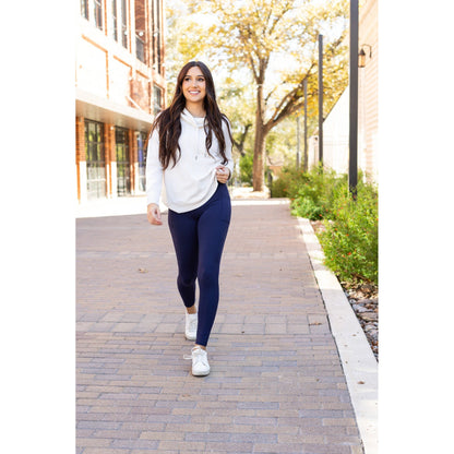 High-waisted navy crossover leggings with pockets by Julia Rose, Julia Rose women’s navy full length leggings lifestyle image