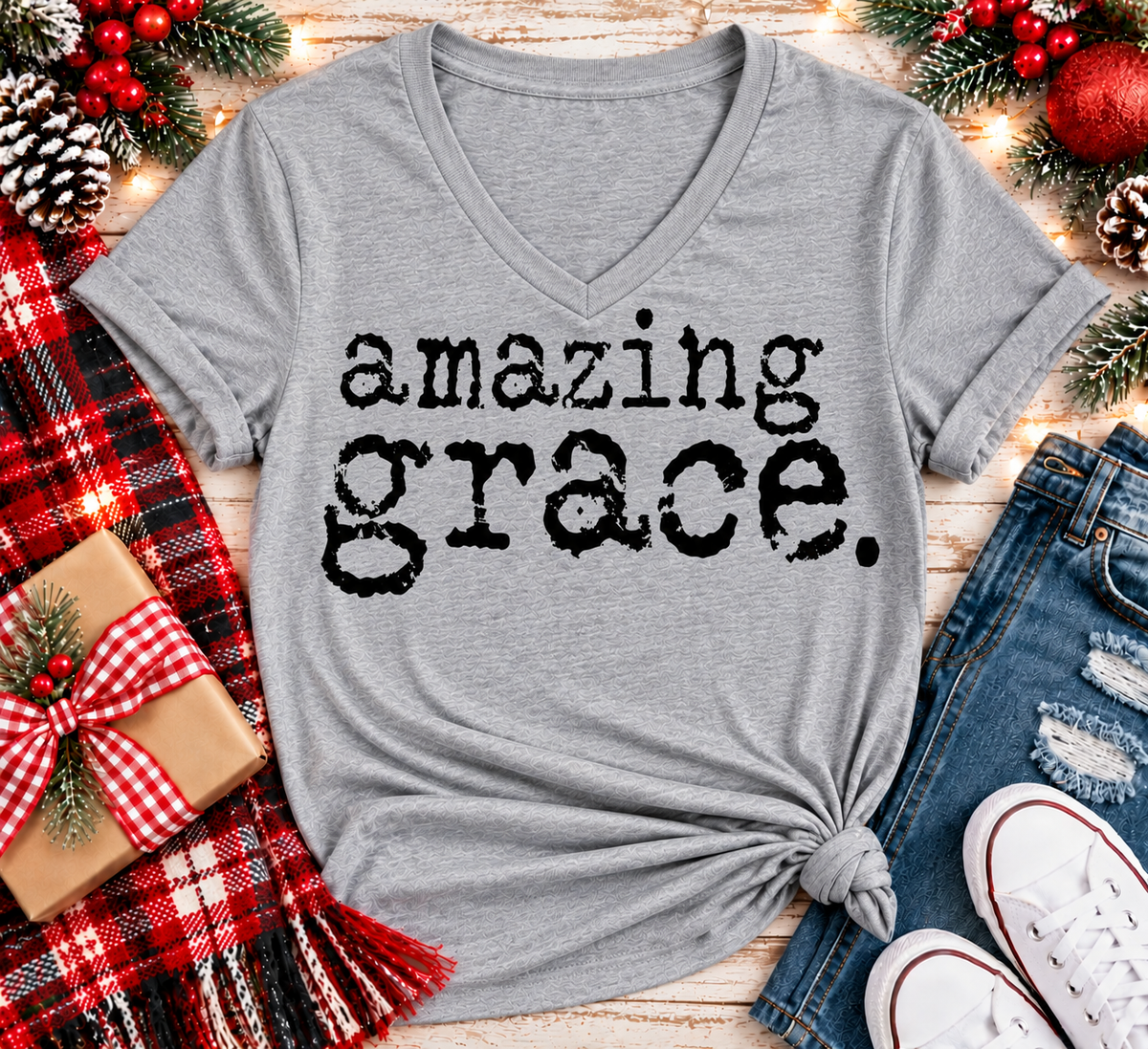 A heather gray V-neck t-shirt with the words 'amazing grace.' printed in a distressed black typewriter font.