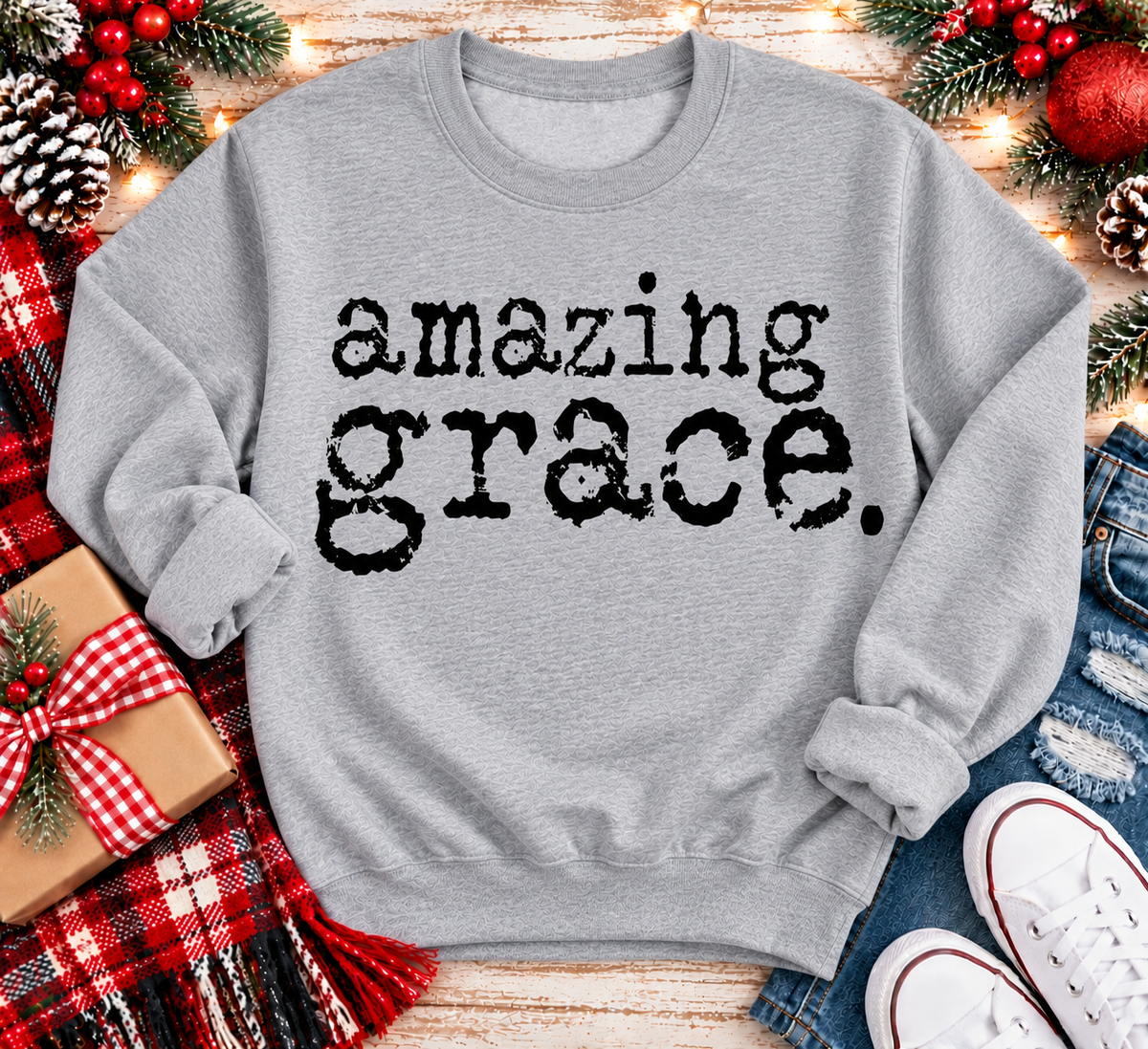A light gray crewneck sweatshirt with the words 'amazing grace.' printed in a black distressed typewriter font.