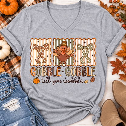 Gobble Gobble Till You Wobble Thanksgiving graphic apparel featuring a cute turkey, polka dot bows, retro fall colors, pumpkins and autumn leaves.