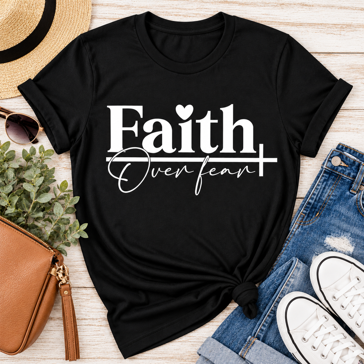 Faith Over Fear Christian inspirational graphic apparel featuring bold white Faith lettering, elegant Over Fear script, a small heart, and a cross design. Available in red and black in short sleeve crewneck, long sleeve crewneck, crewneck sweatshirt, and hoodie styles. Faith-based graphic clothing for women, everyday wear, church outfits, and inspirational gifts.