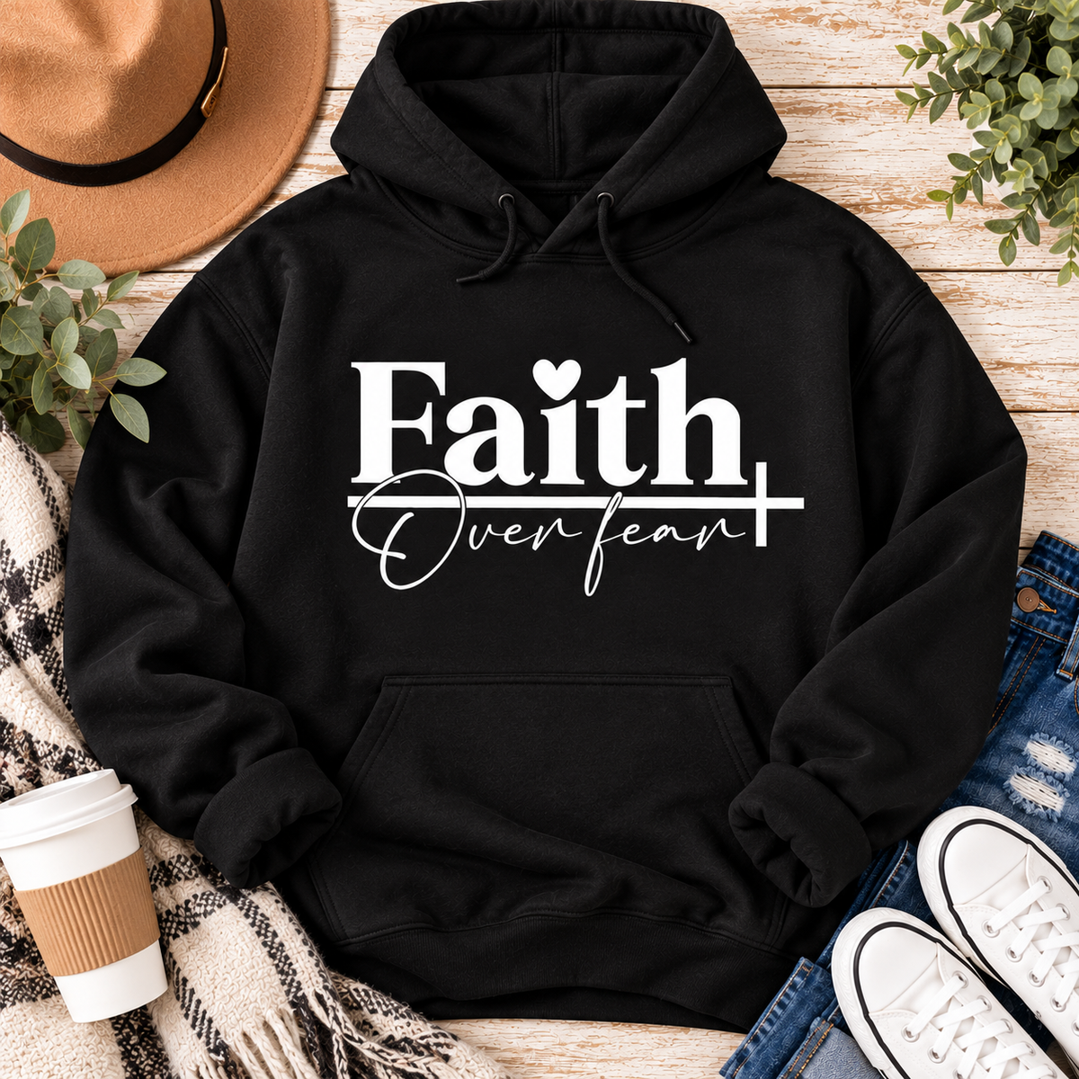 Faith Over Fear Christian inspirational graphic apparel featuring bold white Faith lettering, elegant Over Fear script, a small heart, and a cross design. Available in red and black in short sleeve crewneck, long sleeve crewneck, crewneck sweatshirt, and hoodie styles. Faith-based graphic clothing for women, everyday wear, church outfits, and inspirational gifts.