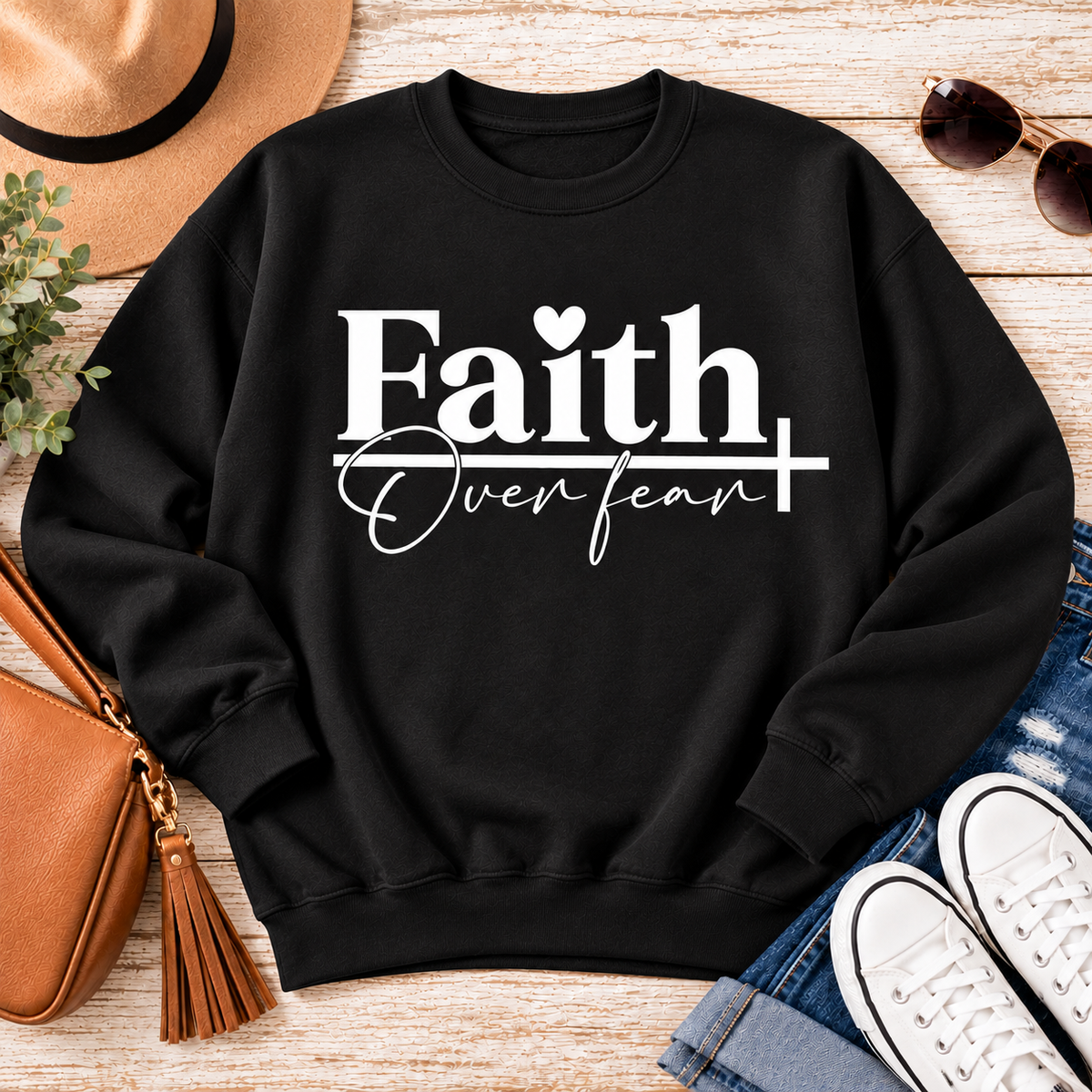 Faith Over Fear Christian inspirational graphic apparel featuring bold white Faith lettering, elegant Over Fear script, a small heart, and a cross design. Available in red and black in short sleeve crewneck, long sleeve crewneck, crewneck sweatshirt, and hoodie styles. Faith-based graphic clothing for women, everyday wear, church outfits, and inspirational gifts.