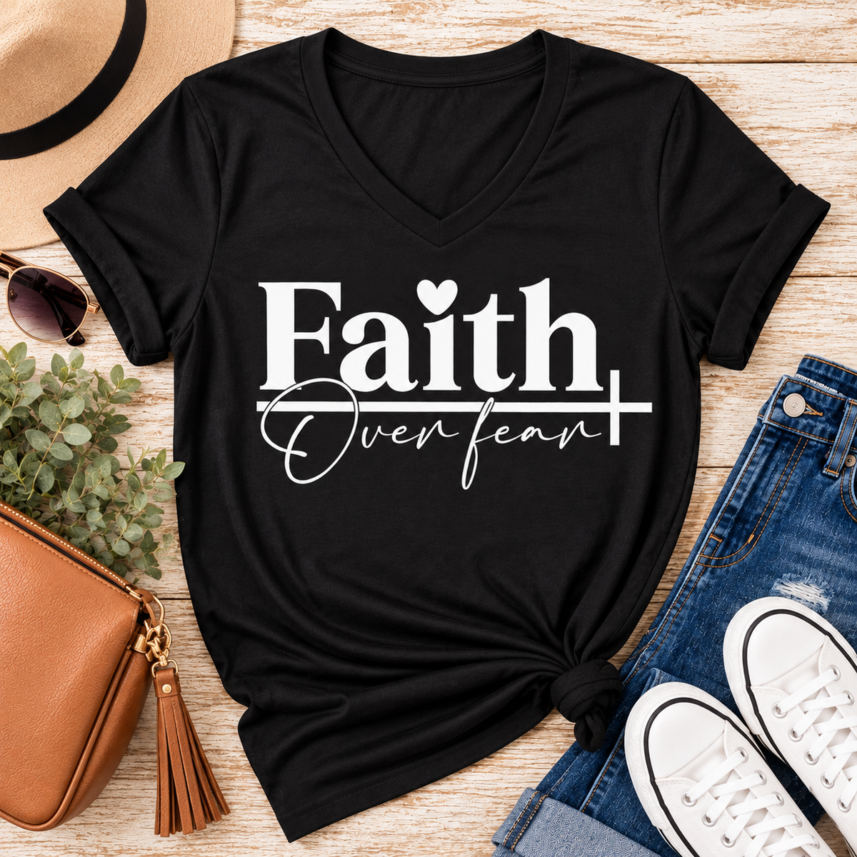 Faith Over Fear Christian inspirational graphic apparel featuring bold white Faith lettering, elegant Over Fear script, a small heart, and a cross design. Available in red and black in short sleeve crewneck, long sleeve crewneck, crewneck sweatshirt, and hoodie styles. Faith-based graphic clothing for women, everyday wear, church outfits, and inspirational gifts.