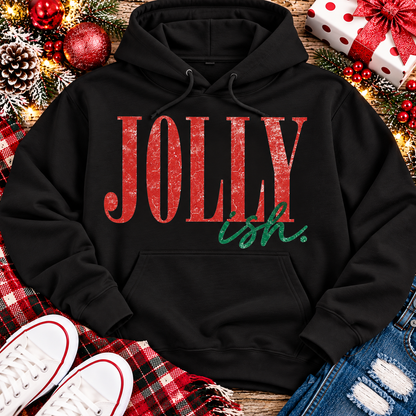 Jolly Ish Christmas graphic shirt featuring large distressed red JOLLY lettering with green handwritten ish script. Funny vintage-inspired holiday apparel available in pink and black, offered in short sleeve crewneck, V-neck, long sleeve and hoodie styles.