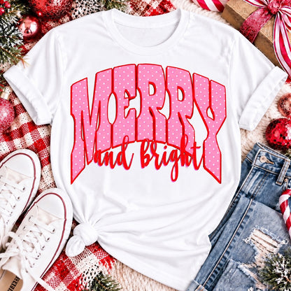 Merry and Bright Christmas graphic apparel with oversized pink polka dot lettering and festive holiday design