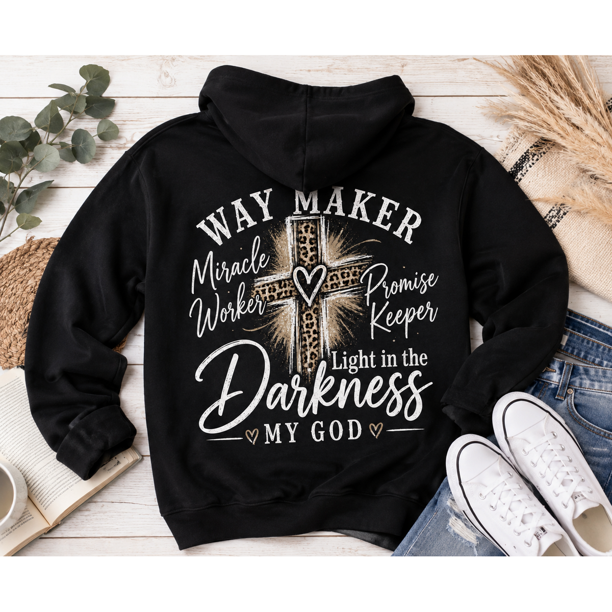 Black hoodie with God heart front graphic and Way Maker leopard cross faith graphic on back